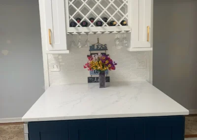 A charming kitchen with a colorful tiled backsplash and vintage-style accessories.