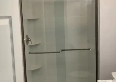 A family bathroom featuring double sinks and kid-friendly step stools.