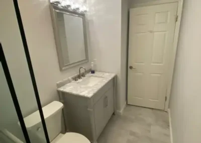 A safe and functional family bathroom with non-slip tiles and bright lighting.