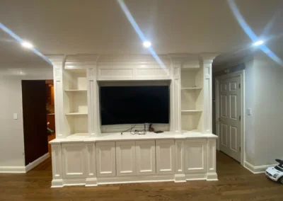 A comfortable TV lounge featuring a sectional sofa, modern decor, and a wall-mounted television.