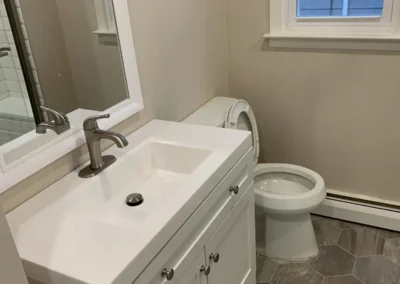 An eco-friendly bathroom with recycled wood accents and a low-flow toilet.