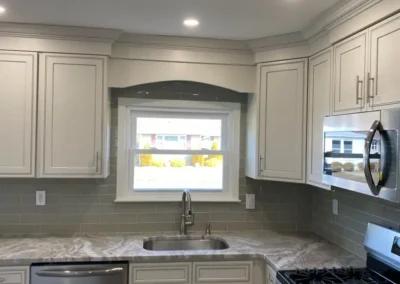 A dual-tone kitchen featuring dark lower cabinets and light upper cabinets for contrast.