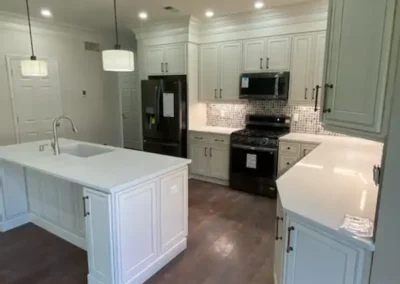A chef’s kitchen with stainless steel professional-grade appliances and a large island.