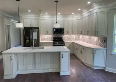 A cozy kitchen with a brick accent wall, wooden shelves, and pendant lights.
