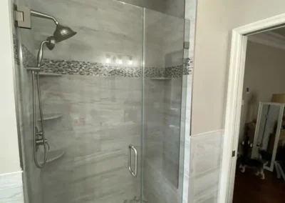 A small bathroom with space-saving shelves and a compact sink.