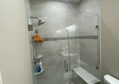 A traditional bathroom featuring a classic clawfoot tub and mosaic tile flooring.