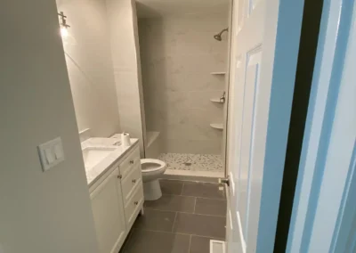 bathroom lighting and natural stone tiles.