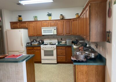 A modern kitchen with integrated LED lighting under cabinets and inside drawers.