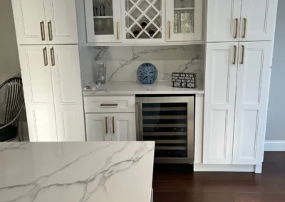A retro kitchen featuring a checkerboard floor and vintage appliances in pastel tones.