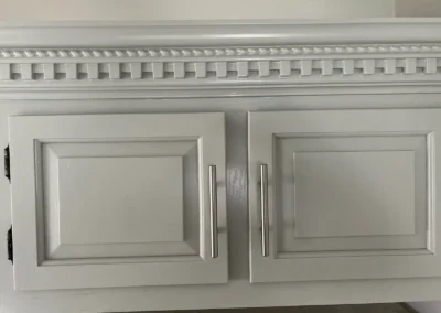 A contemporary kitchen with bold statement lighting fixtures over a central island.