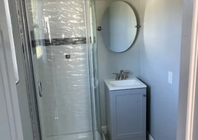 A functional bathroom designed with a built-in makeup vanity and ample lighting.